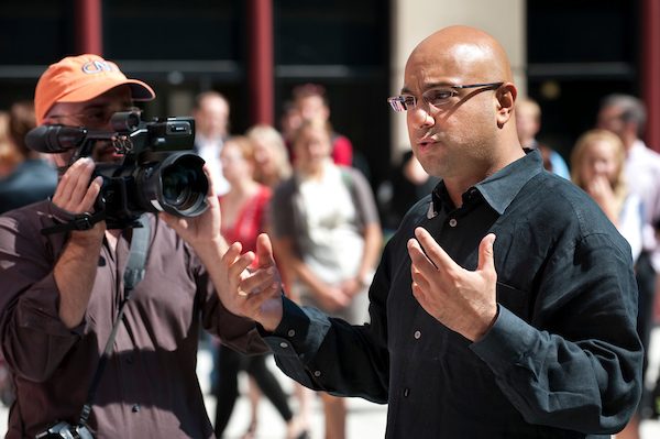 CNN's chief business correspondent Ali Velshi (at right in black shirt) ask questions of UW–Madison students commenting about the state of the American economy as a CNN Express video crew tapes the town hall-style meeting in the courtyard of Grainger Hall at the Wisconsin School of Business.