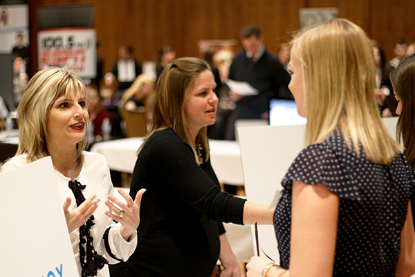 Employers speak with students at a career fair