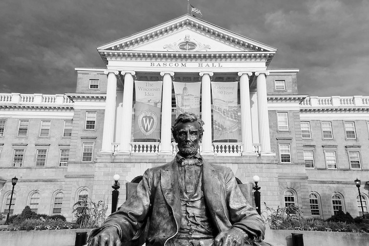 A statue of Abraham Lincoln sits in front of Bascom Hall atop Bascom Hill.