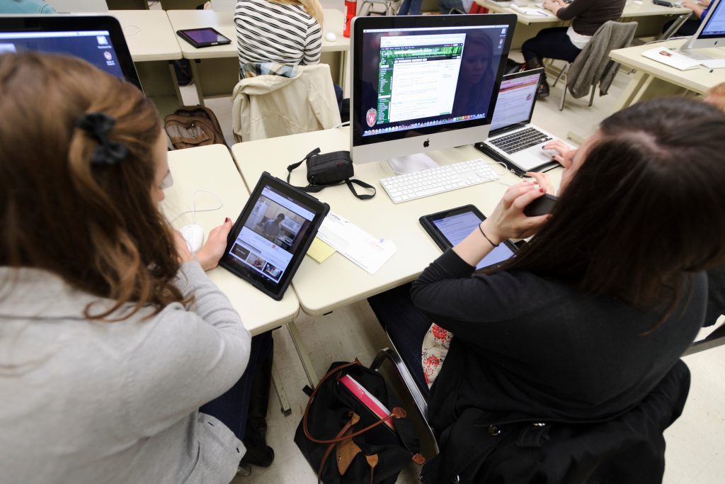 journalism students working on iPads and computers