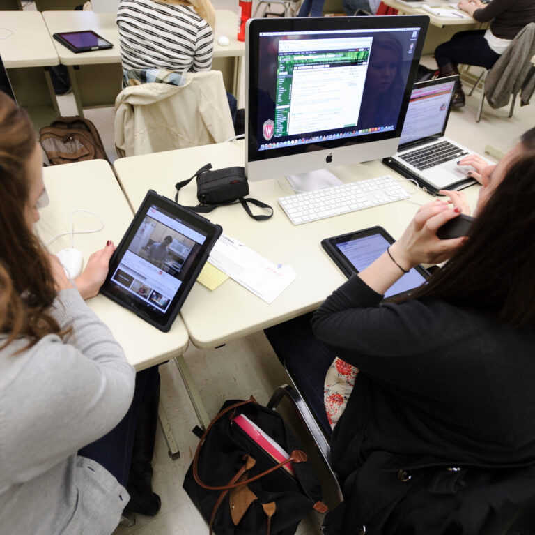 Journalism students working on iPads and computers