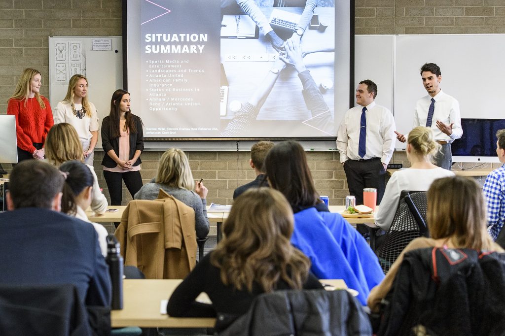 Students in a Digital Media Strategies class taught by Debra Pierce, faculty associate in the School of Journalism and Mass Communication at the University of Wisconsin-Madison, make presentations on their solutions to real-world business communication problems to a panel.