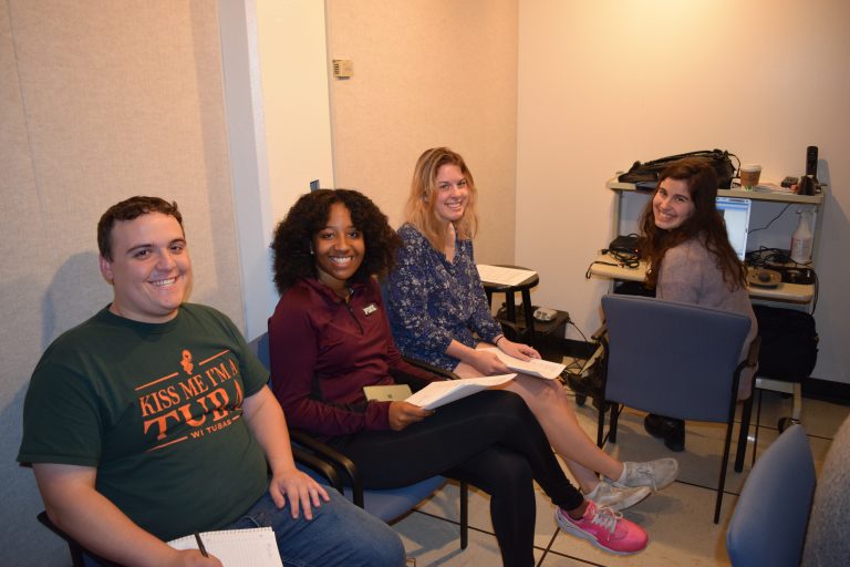 Four students working behind the scenes on The Badger Report