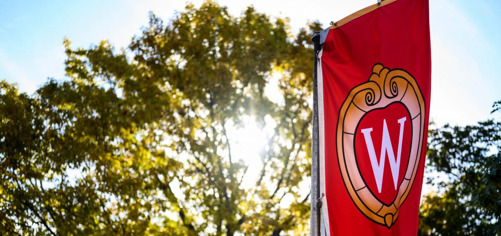 A W crest banner flutters in the wind on Bascom Hill at the University of Wisconsin-Madison during autumn on Oct. 18, 2019. (Photo by Jeff Miller /UW-Madison)
