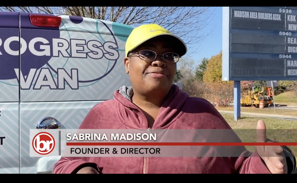 A woman in a baseball cap stands in front of the Progress Van. The photo is captioned 'Sabrina Madison, Founder & Director'.