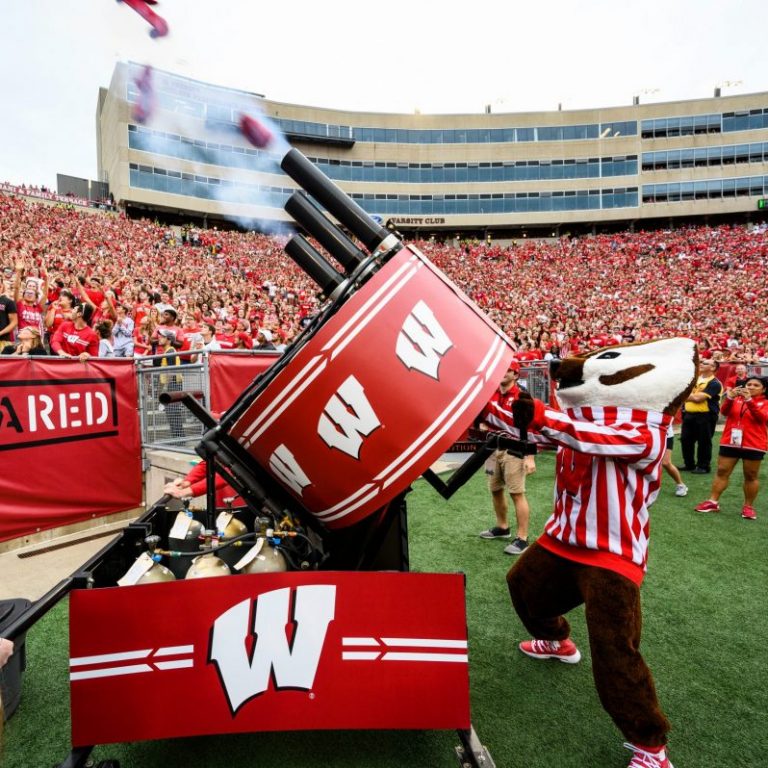 Bucky Badger fires a T Shirt cannon into the crowd at Camp Randall Stadium