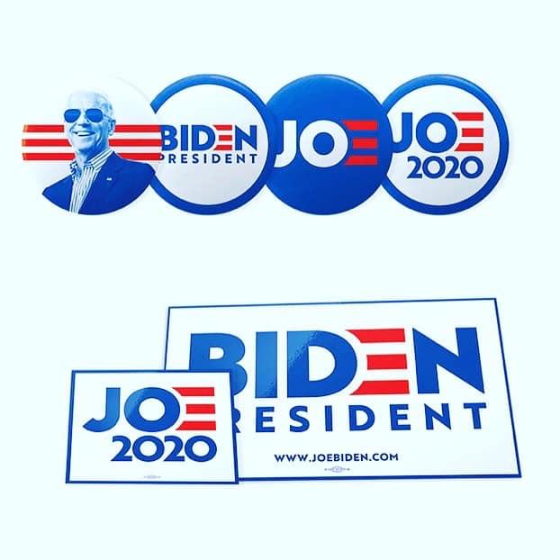 Buttons and stickers with Joe Biden's logo and branding on them.