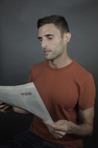 Jacob Kushner reading a newspaper