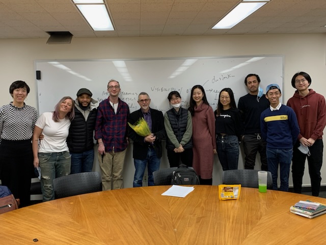 Professor Lew Friedland stands with a group of students during his final lecture