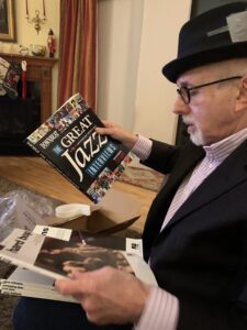 Lew Friedland opens a gift of books on jazz piano