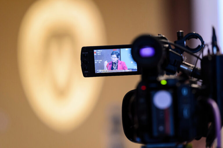 An image of UW-Madison Chancellor Rebecca Blanks is displayed on a video camera as she speaks.