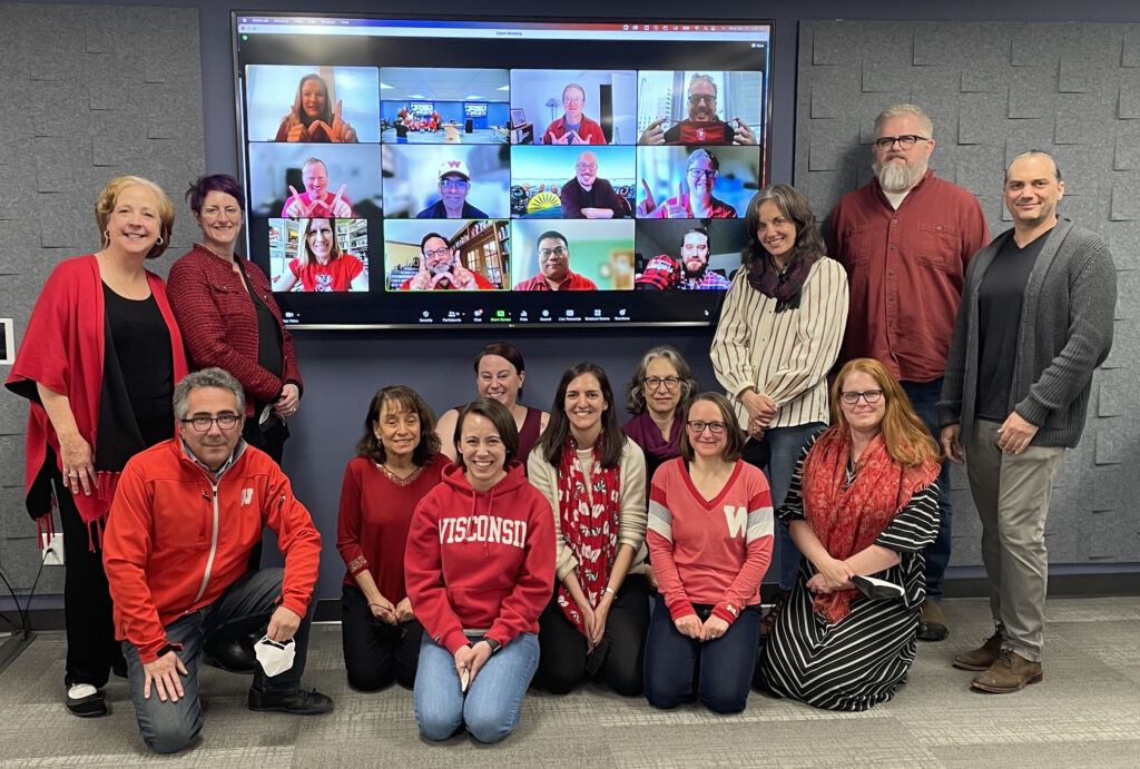 The faculty and staff of the School of Journalism and Mass Communication wearing red