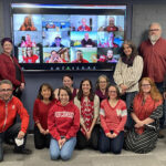 The faculty and staff of the School of Journalism and Mass Communication wearing red