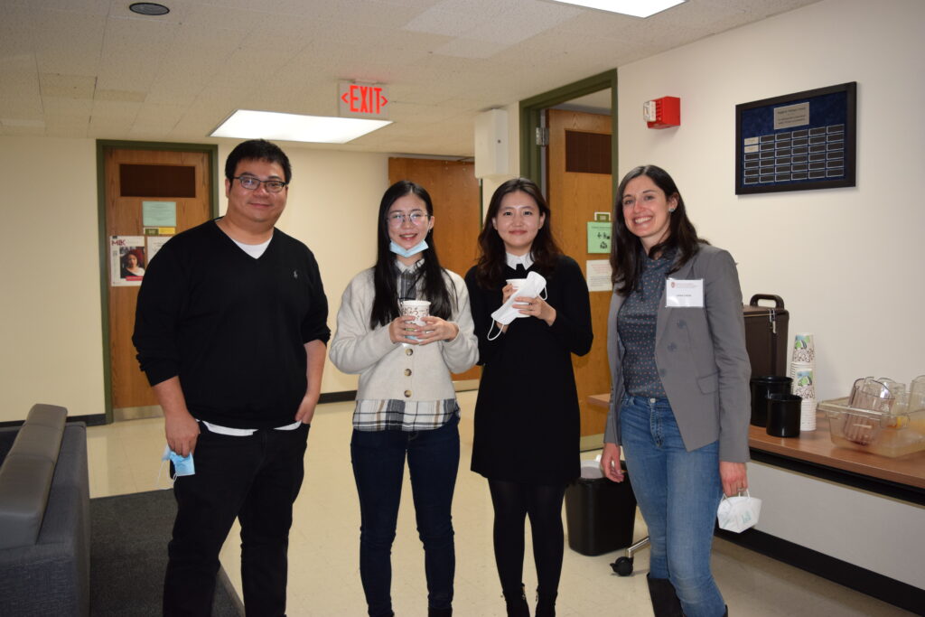 Professor Sijia Yang stands with students outside the Communication Crossroads Conference 2022.