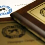 A close up shot of three Milwaukee Press Club awards
