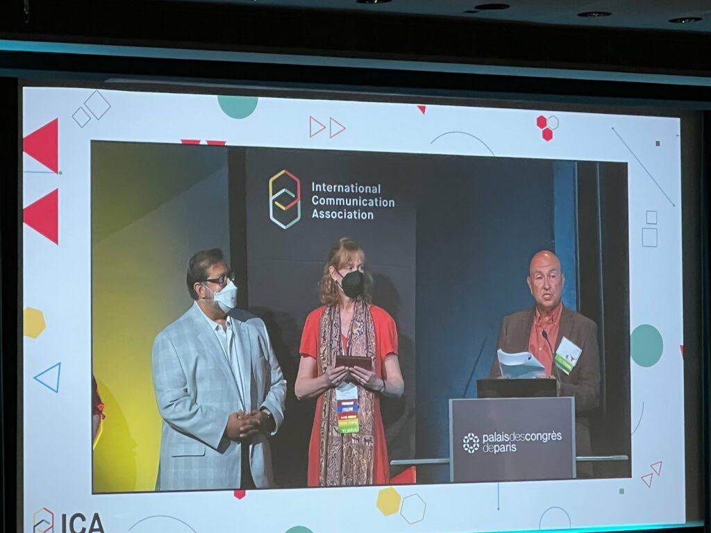 Dhavan Shah on stage at the ICA Conference receiving the B. Audrey Fisher Mentorship Award