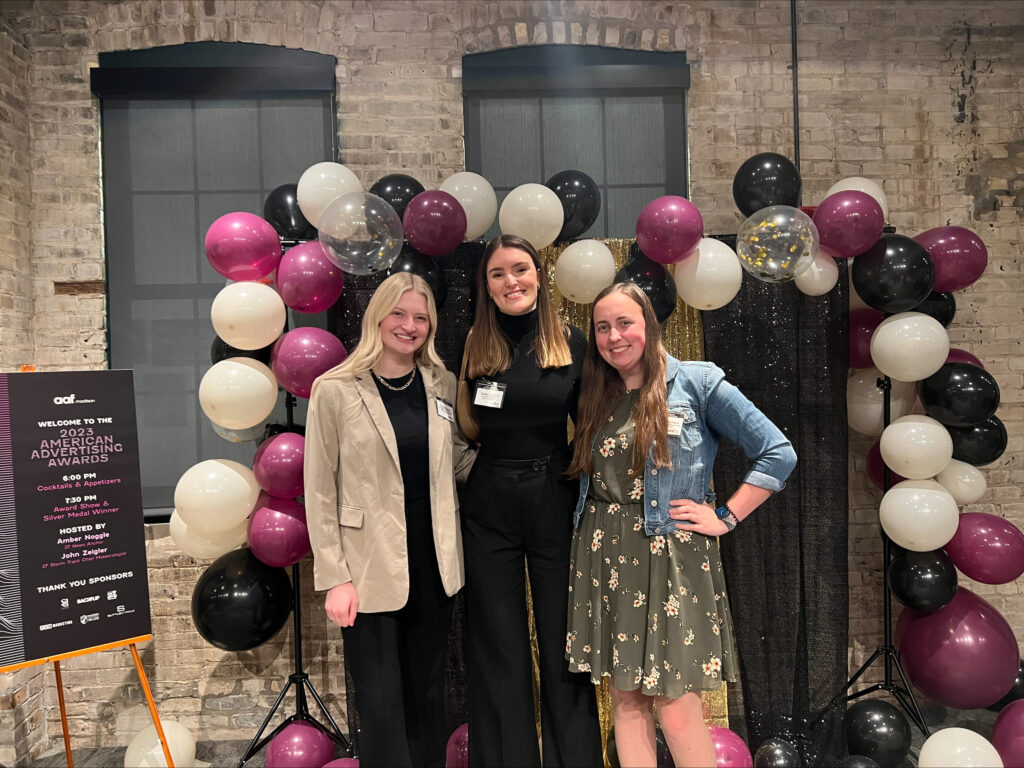 Three students pose at the 2023 American Advertising Awards in Madison, Wisconsin