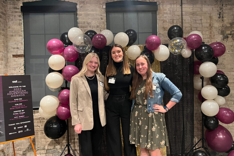 Three students pose at the 2023 American Advertising Awards in Madison, Wisconsin