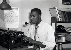 Bob Teague was an accomplished journalist. He is pictured here typing on a typewriter.