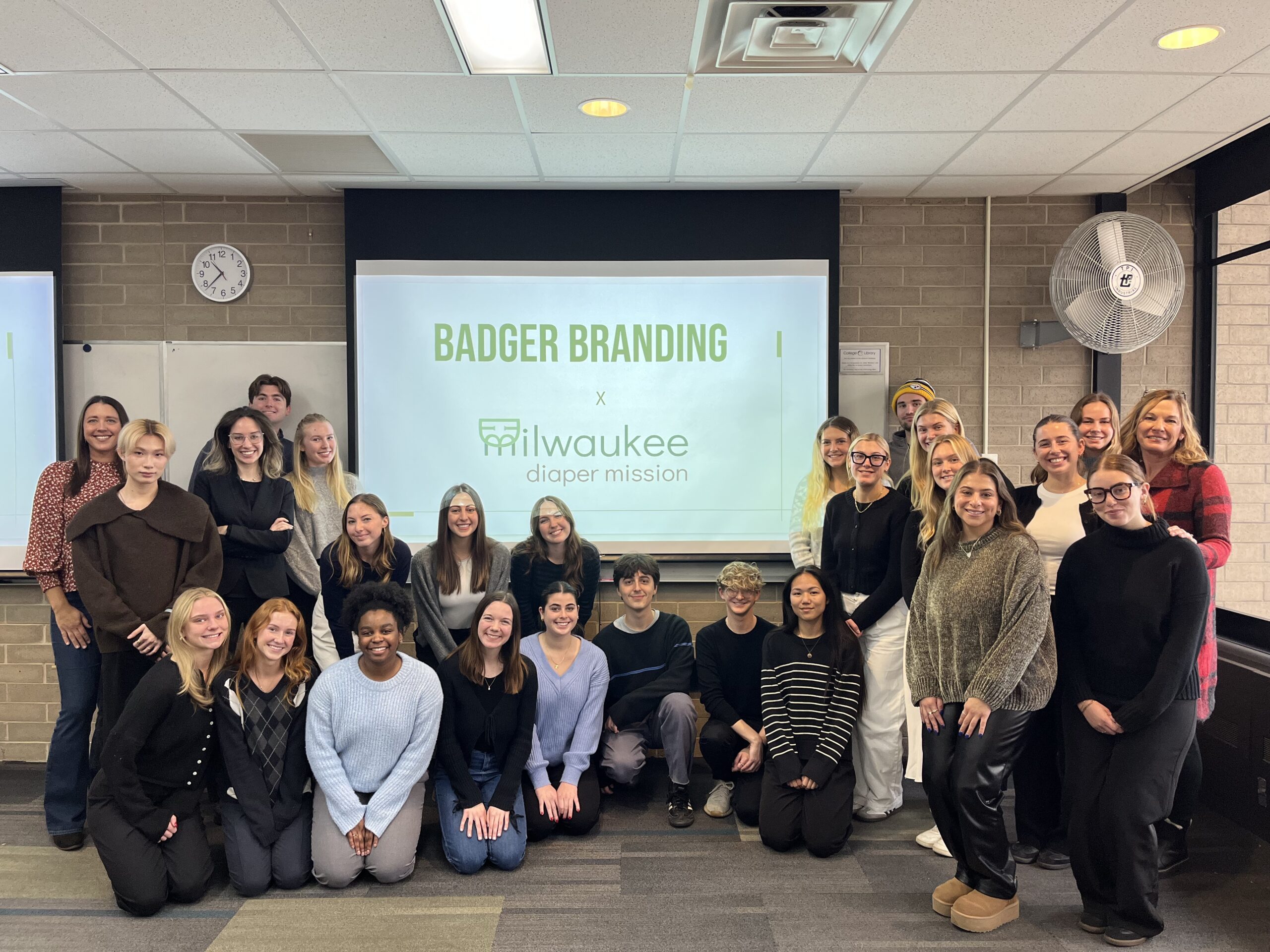 Students in Distinguished Teaching Faculty member Deb Pierce's J463: Digital Media Strategies class pose together with Founder and Executive Director Meagan Johnson.