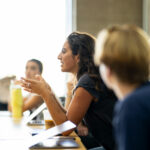 A student participates in a class lecture.