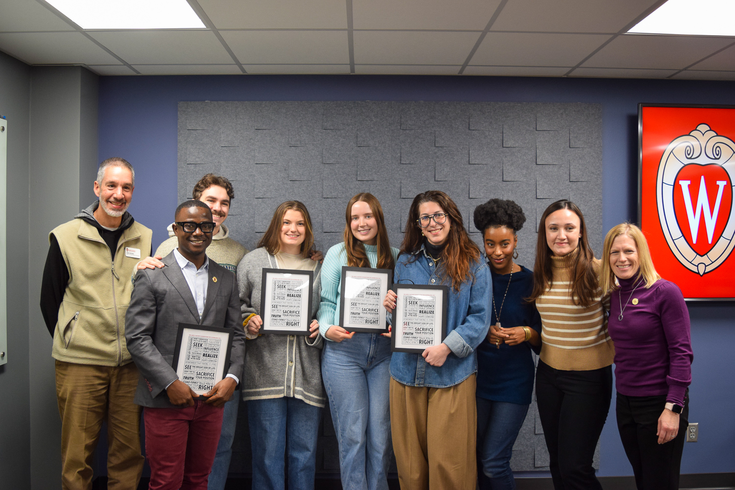 Professional MA graduates pose together after presenting their final portfolios