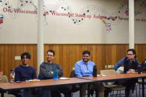 Four students listen at a storytelling workshop