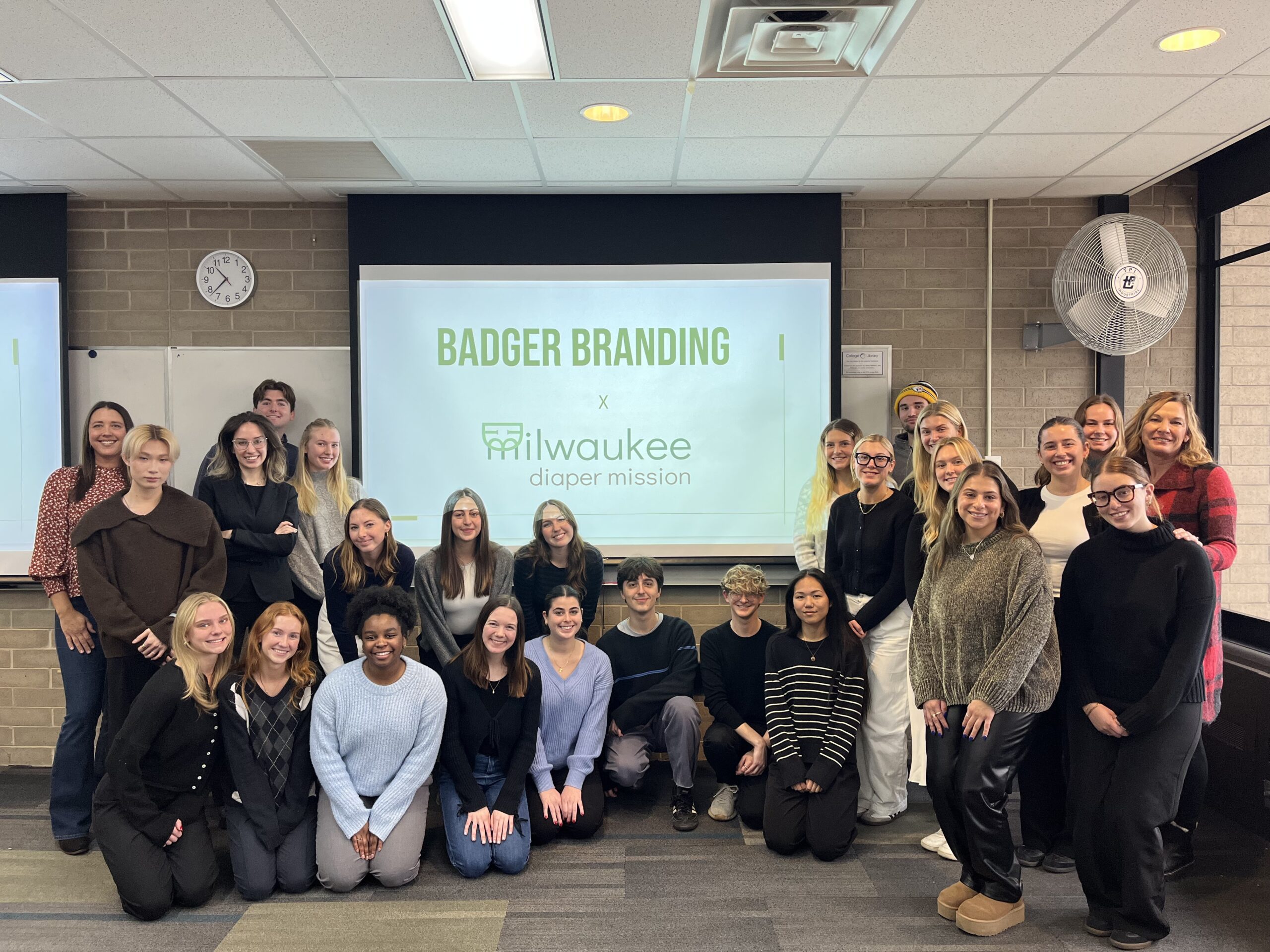 Students pose together after their media plan pitches to the Milwaukee Diaper Mission.